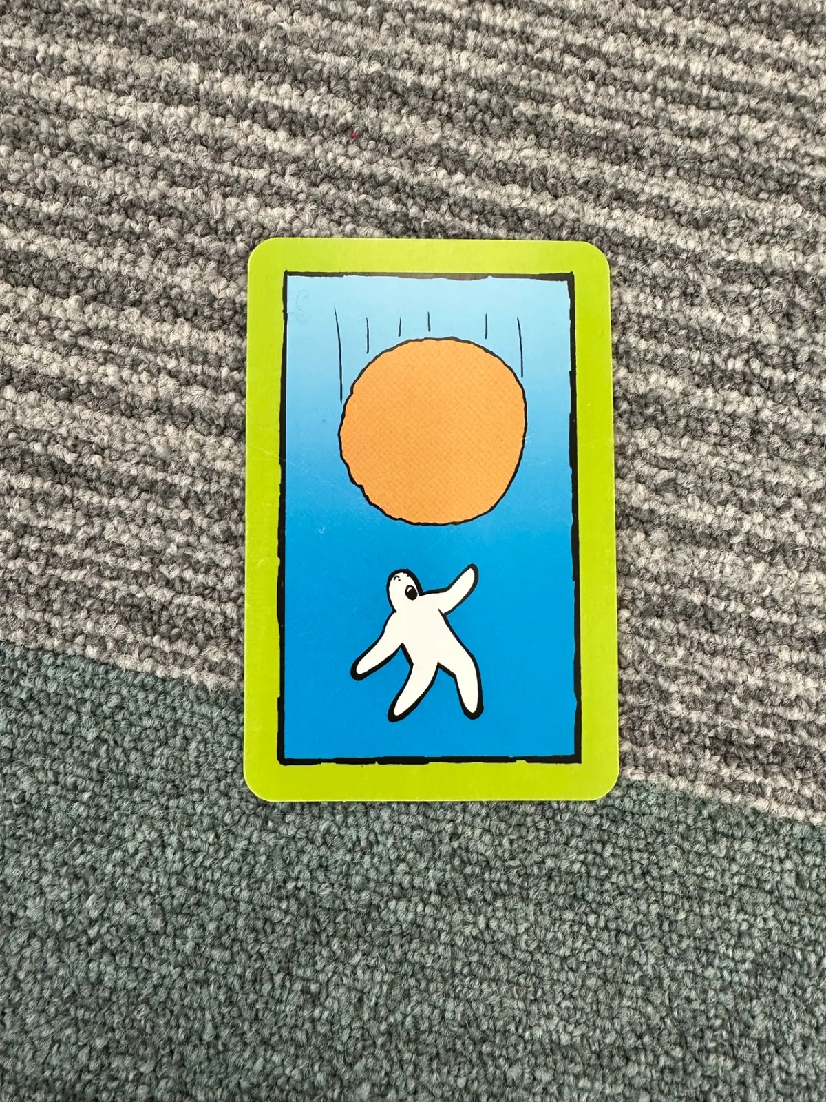 A picture card showing a small figure reaching toward an orange sun