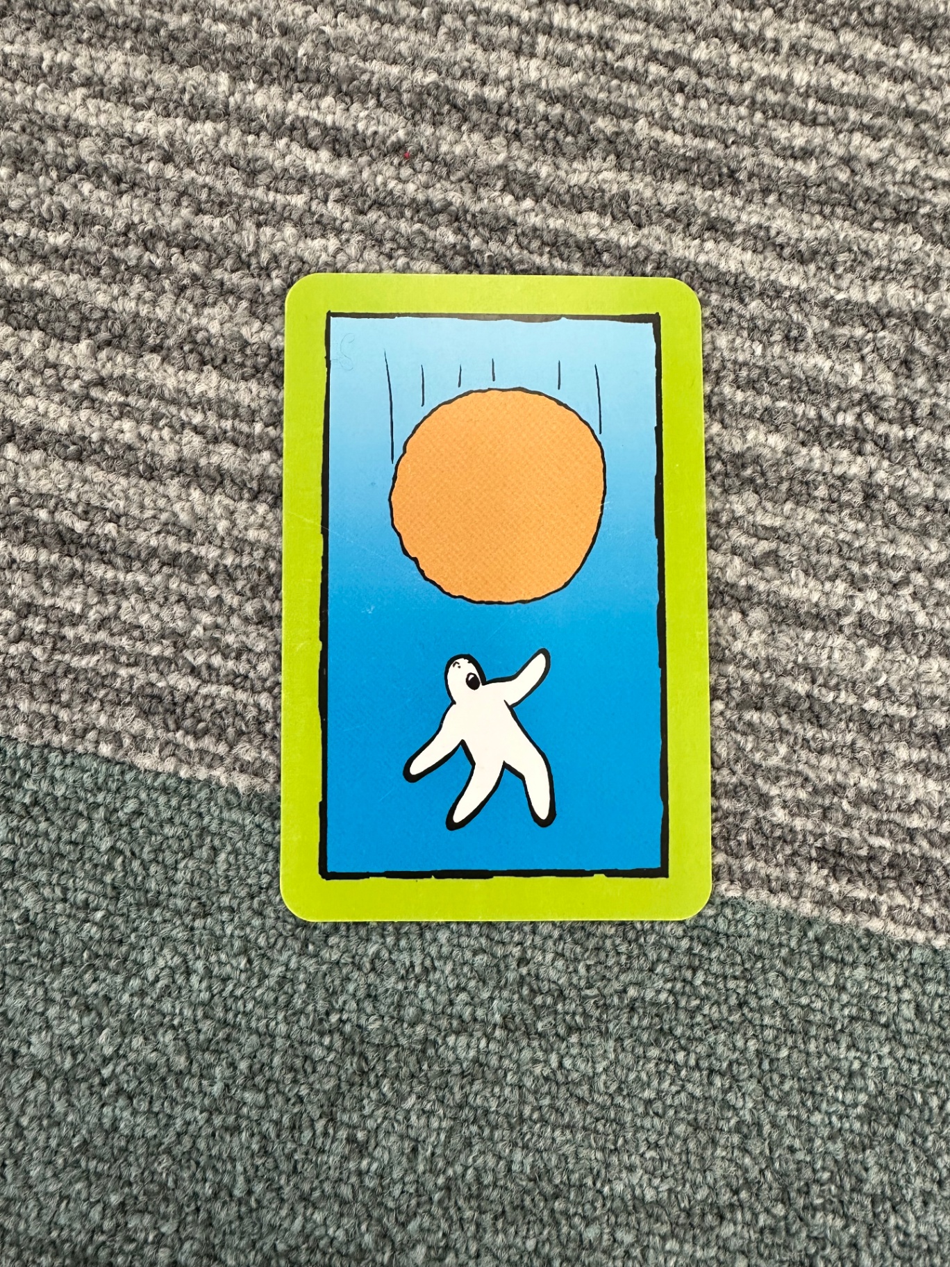 A picture card showing a small figure reaching toward an orange sun