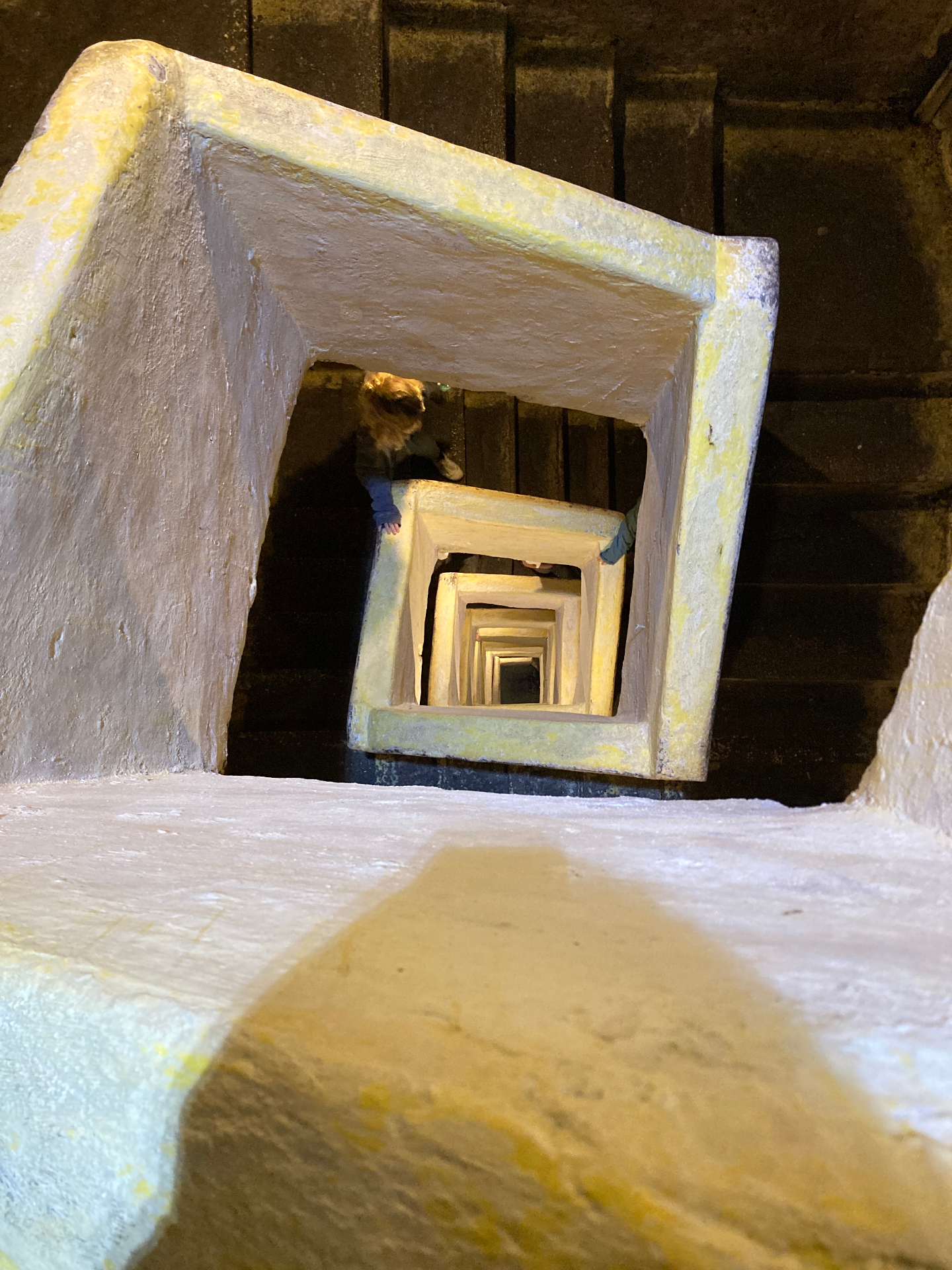 Looking down a spiral of stone staircases